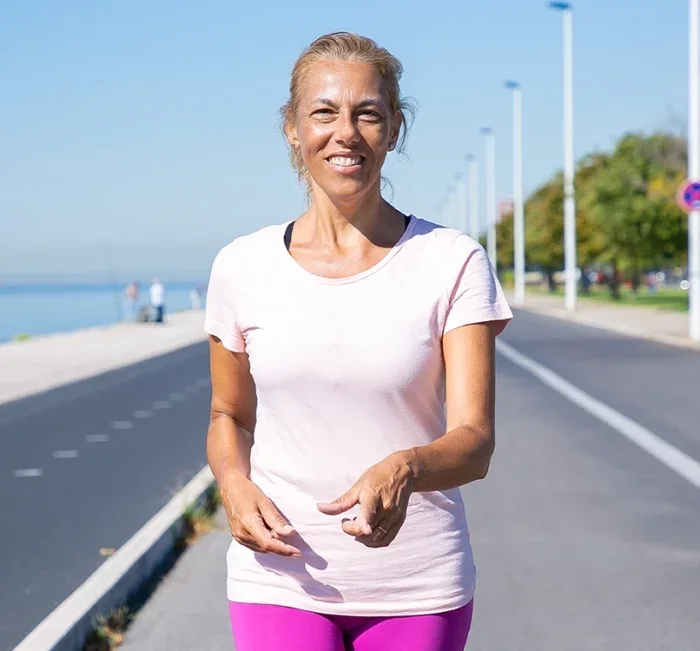 Active woman walking outdoors with steady energy